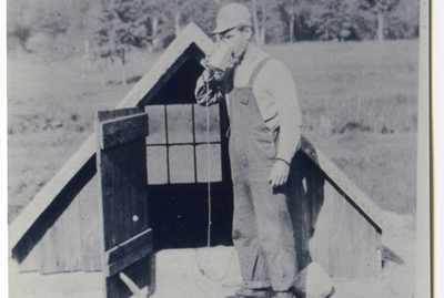 Drinking from the water well – 1934, Albert Shaw drinking water from the original well on the farm. It was located about 50 feet south of the shed on the end of the barn. The site of the original well was later used as a pig pen